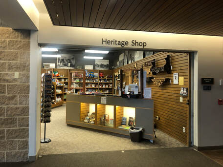 Photo of the entrance of a museum gift shop. Heritage Shop is posted above the doorway.