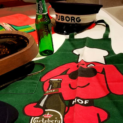 Image: a collection of Carlsberg Group merchandise. Carlsberg Group is a global brewer based in Denmark with a portfolio of popular beer brands.